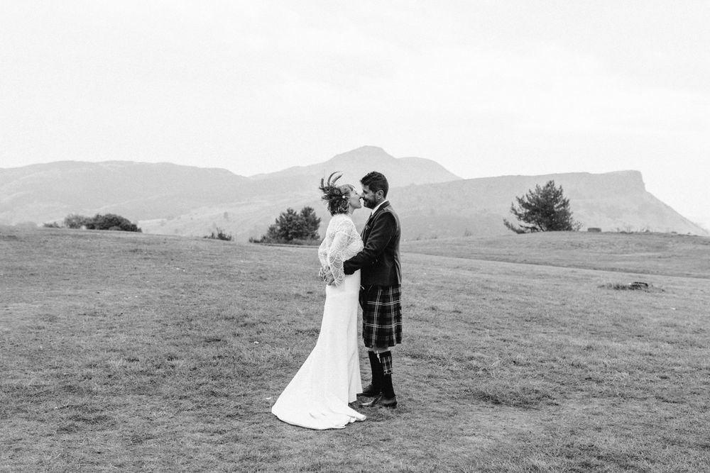 Panoramic black and white wedding photos showing a couple on a rolling hillside.