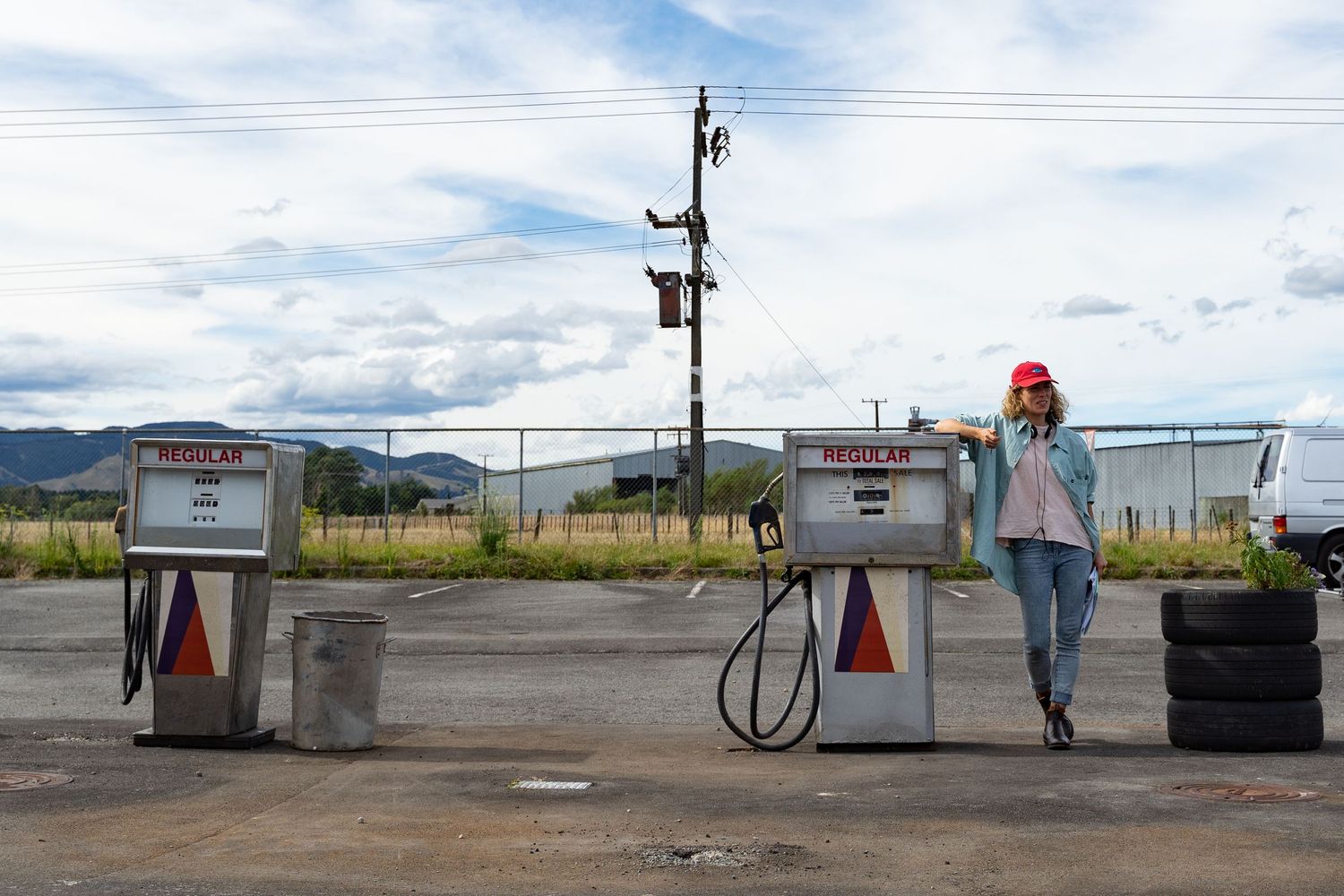 Director Loren Taylor stands by a petrol pump outside on the forecourt on the set of the movie THE MOON IS UPSIDE DOWN