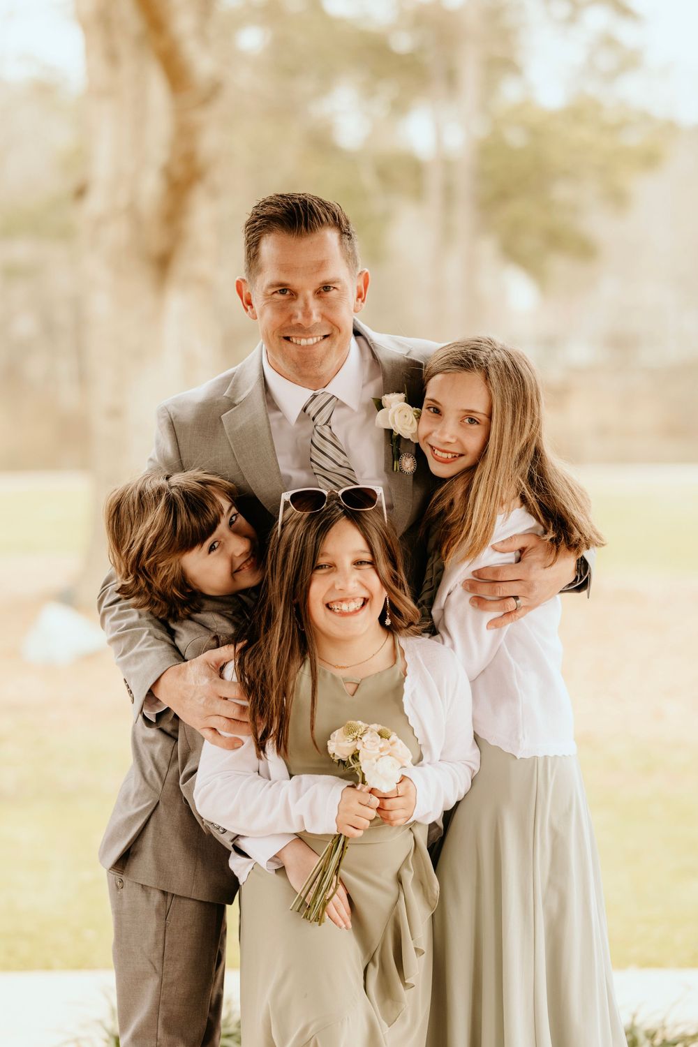 A touching family portrait with children sharing joyful smiles.