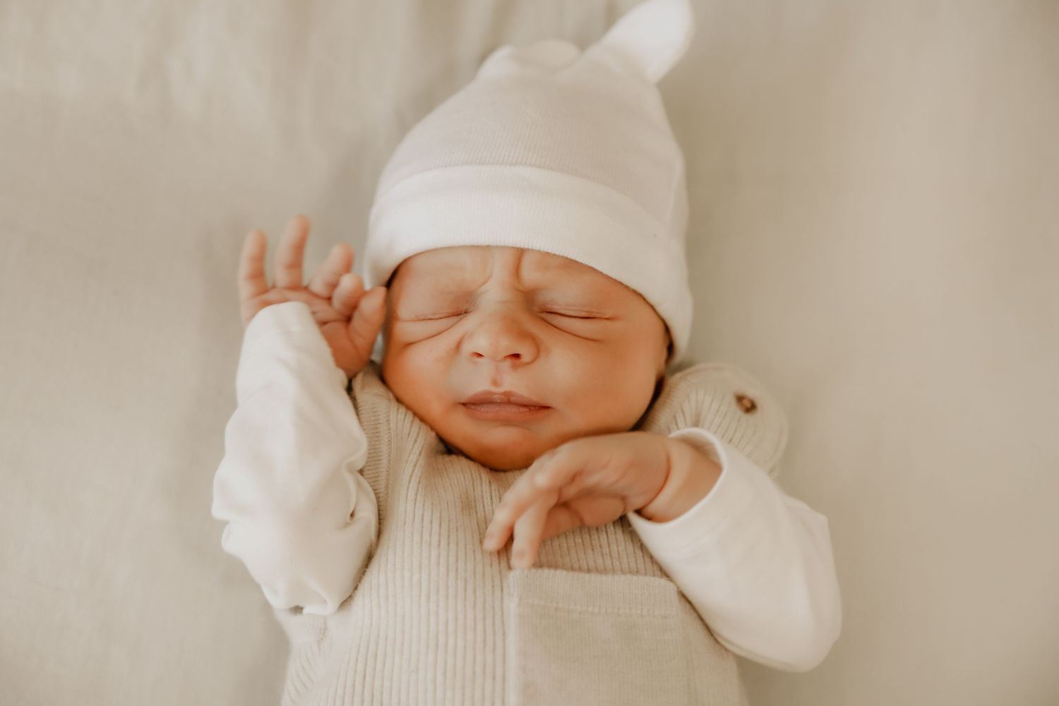 Stretches and sleeps during a Newborn Lifestyle Session.