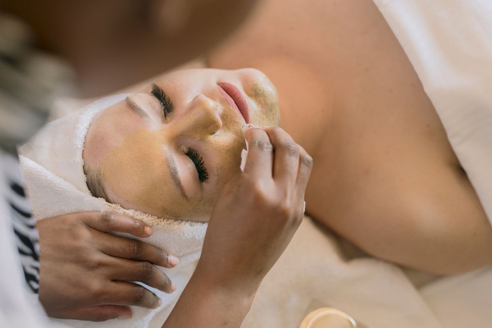 Woman receiving a professional facial skincare treatment at a beauty spa.