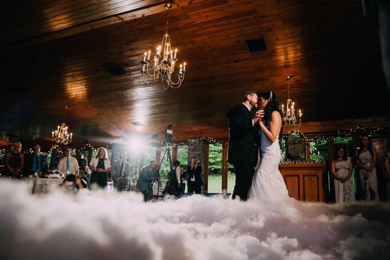 In intimate dance in the clouds first dance. Angie and Chris are portrayed floating amongst  clouds with candles above.