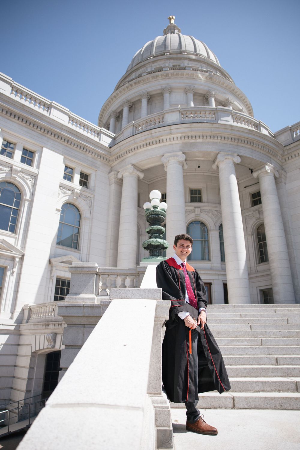Sequence of wide angle architectural shots showing white marble steps and columns of government building with domed roof.