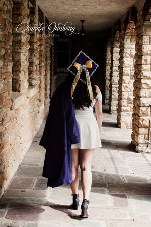 Stylish silhouettes walking through a brick archway corridor.