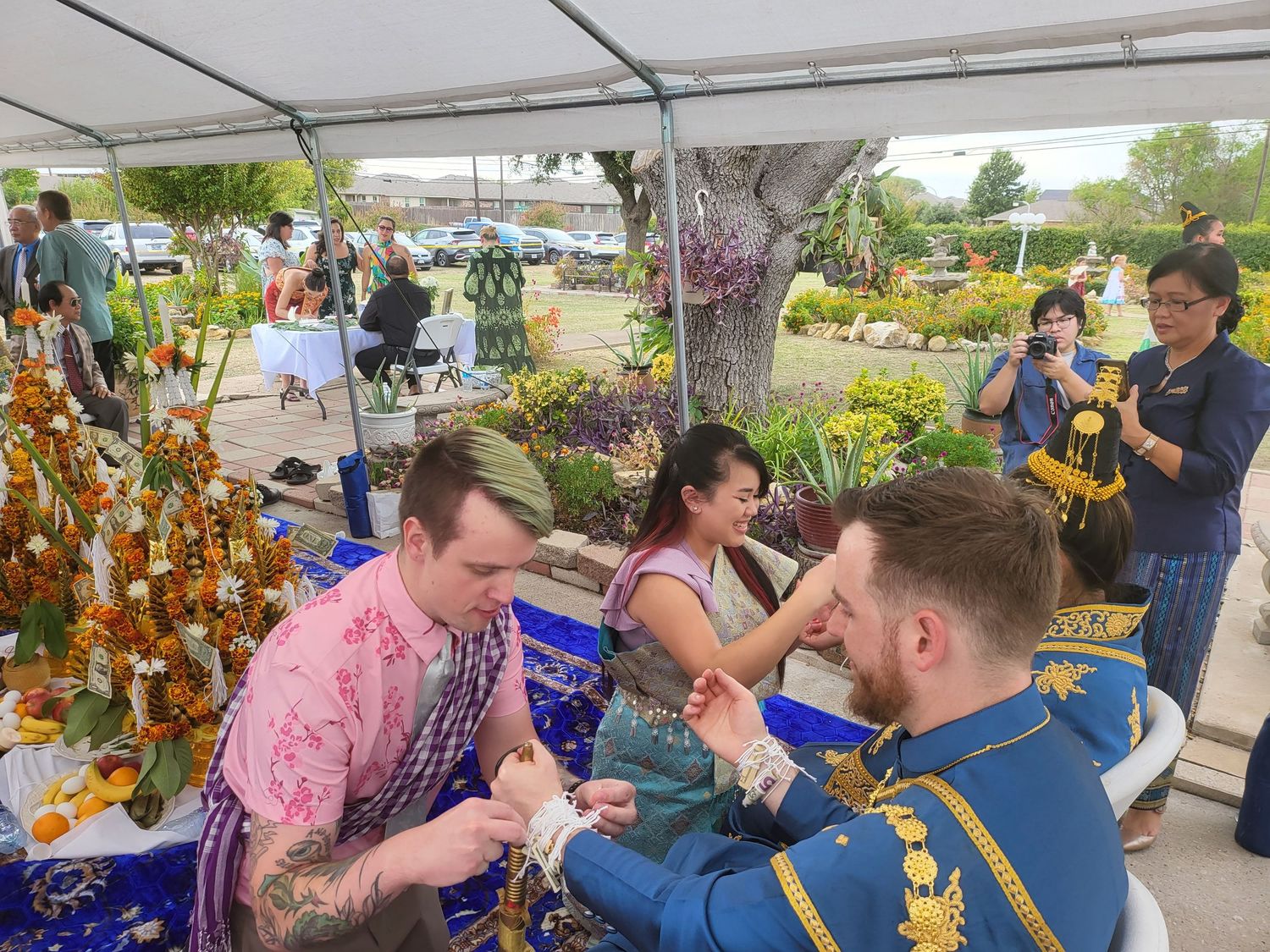A group of people experiencing a refreshing beer tasting event at an outdoor venue with sunflowers in the background.