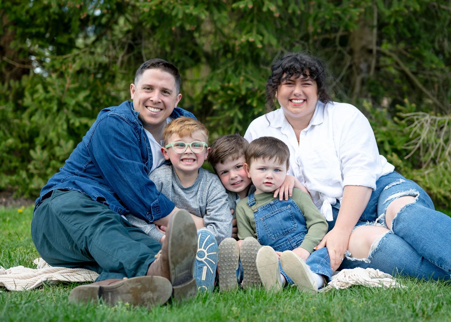 Family all snuggled together outside sitting on a blanket. Wrightstown NJ Family Photographer