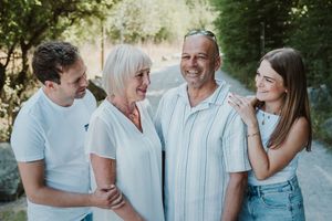 Candid family photo session showing joyful interactions outdoors.