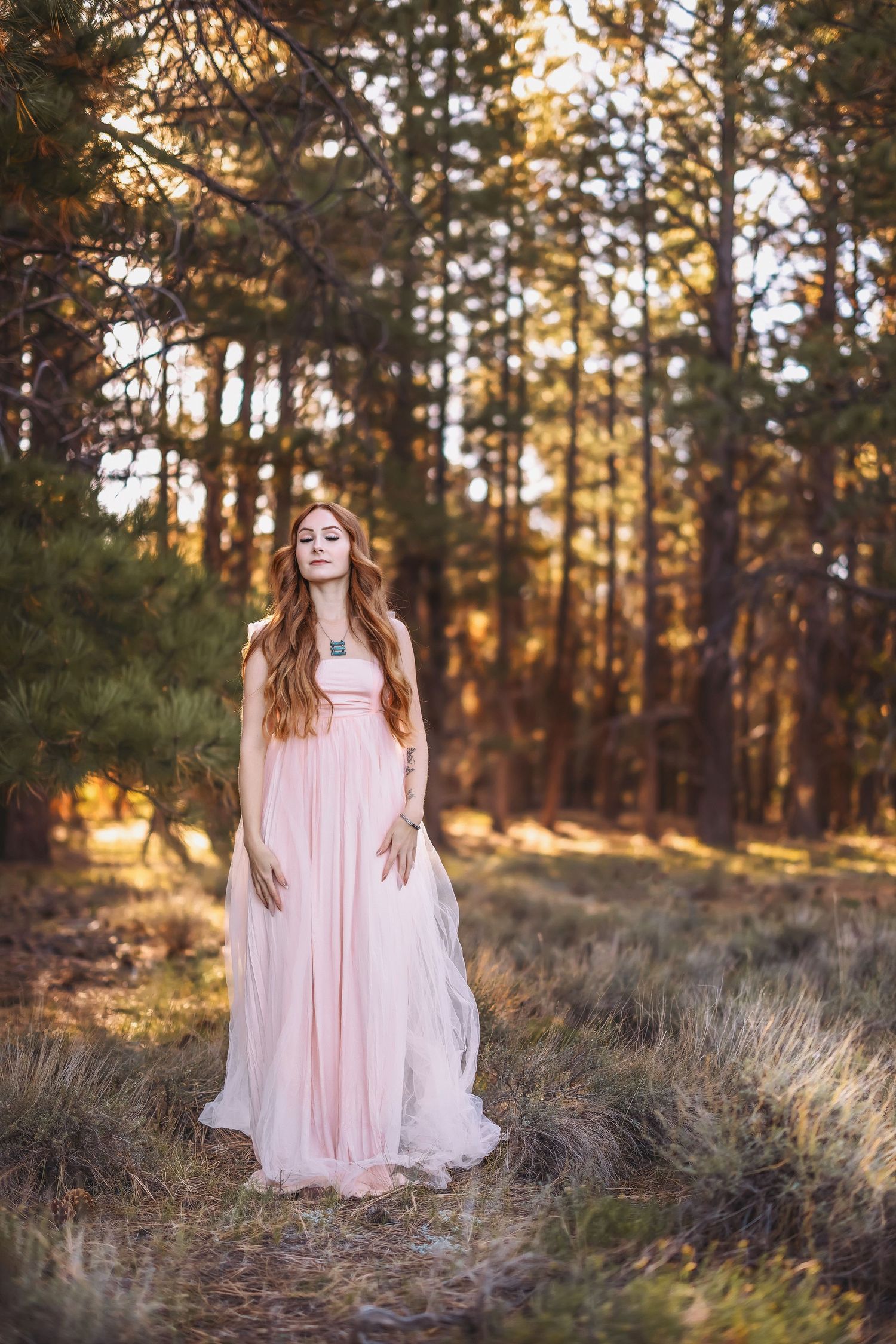 A flowing pink dress catches golden light in a serene forest in Bryce Canyon Utah