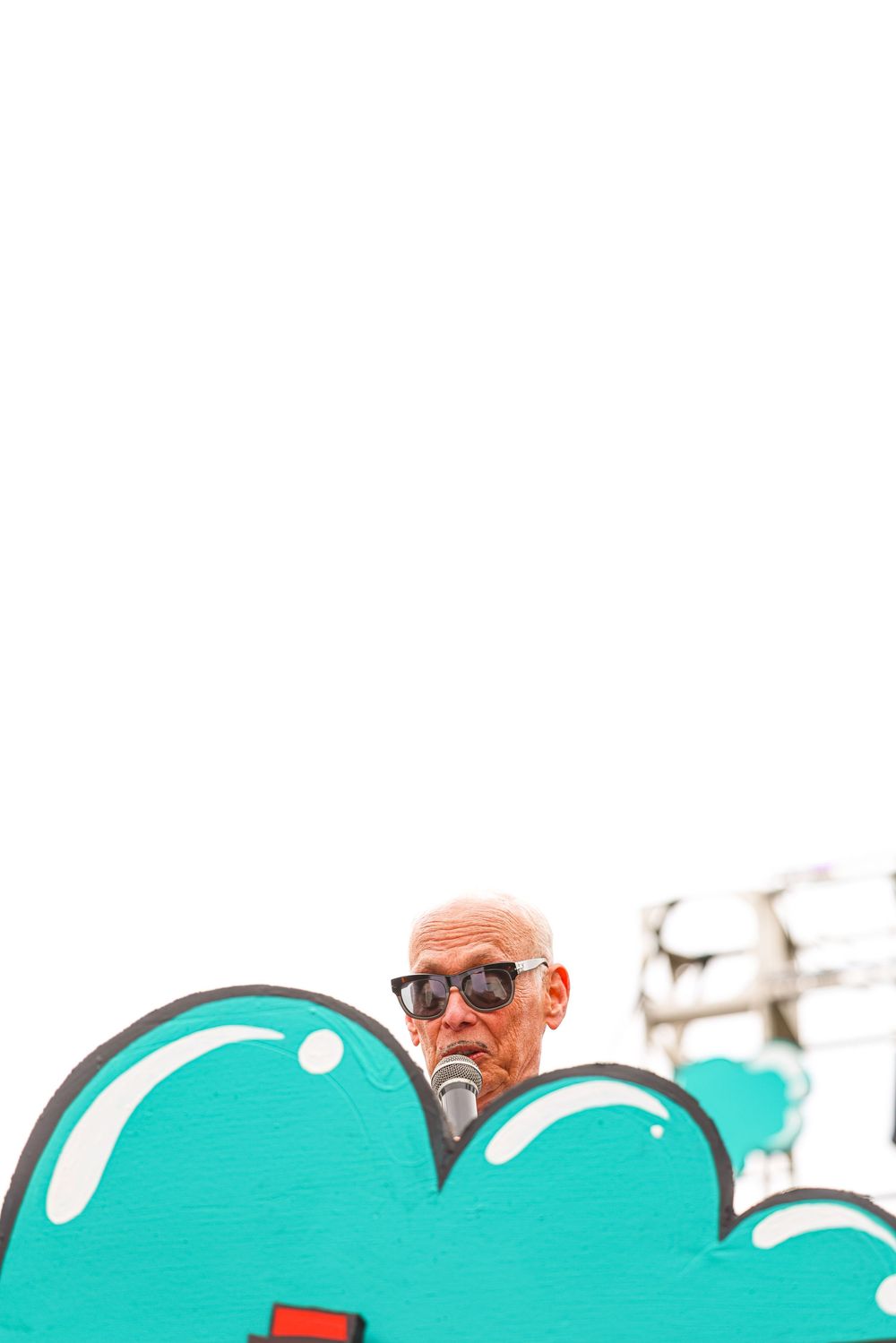 A teal background graphic with illustrated white dots appears like bubbles or soap.