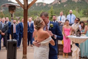 Outdoor mountain wedding ceremony with guests watching first dance.