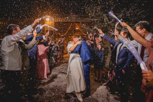 Wedding sparkler exit with guests creating a tunnel of light during the nighttime celebration.