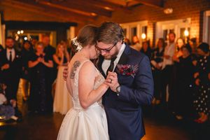 A couple shares an intimate slow dance moment at their wedding reception.