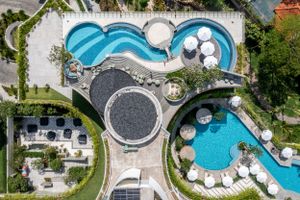 Bird's eye view of resort pools featuring circular designs and outdoor amenities.