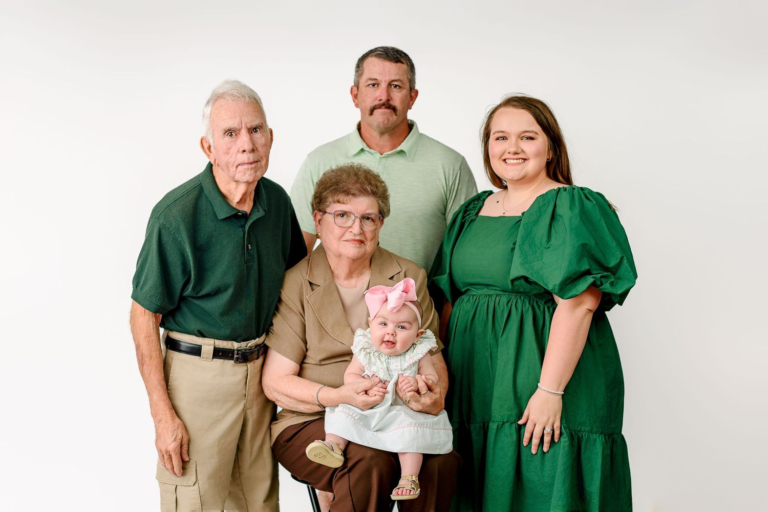 four generations in one photo, grandparents, dad, daughter and granddaughter