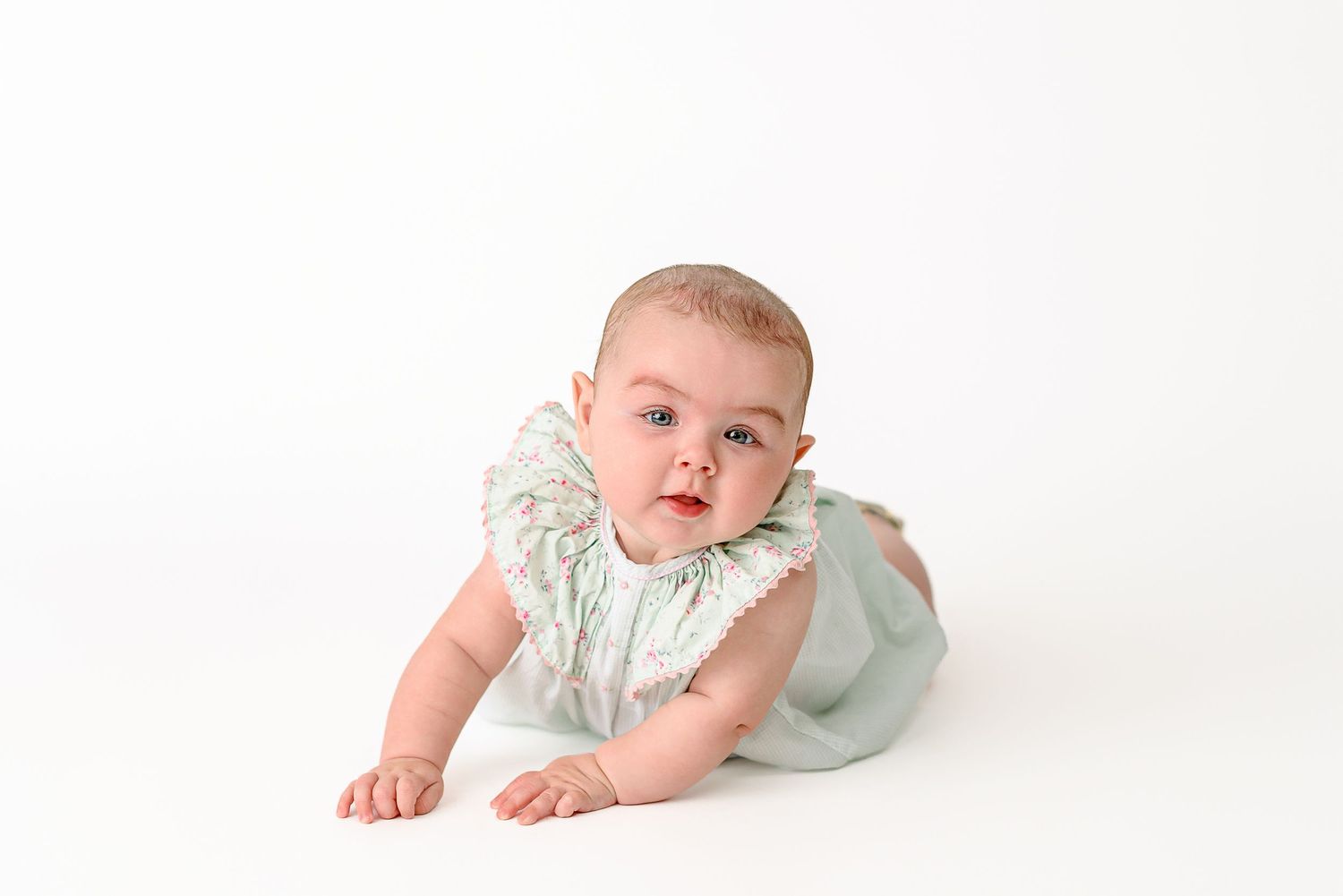 milestone portrait of four month old on white seamless backdrop for a classic and timeless image
