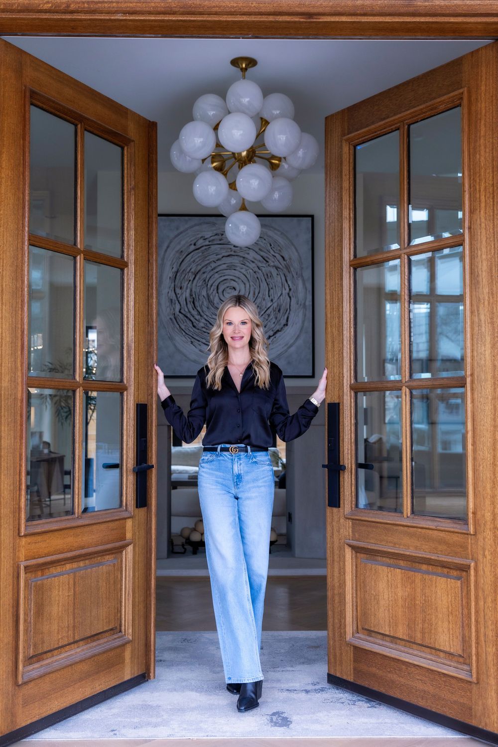 A panoramic view through wooden framed glass doors showing a reflection repeated across multiple panels.