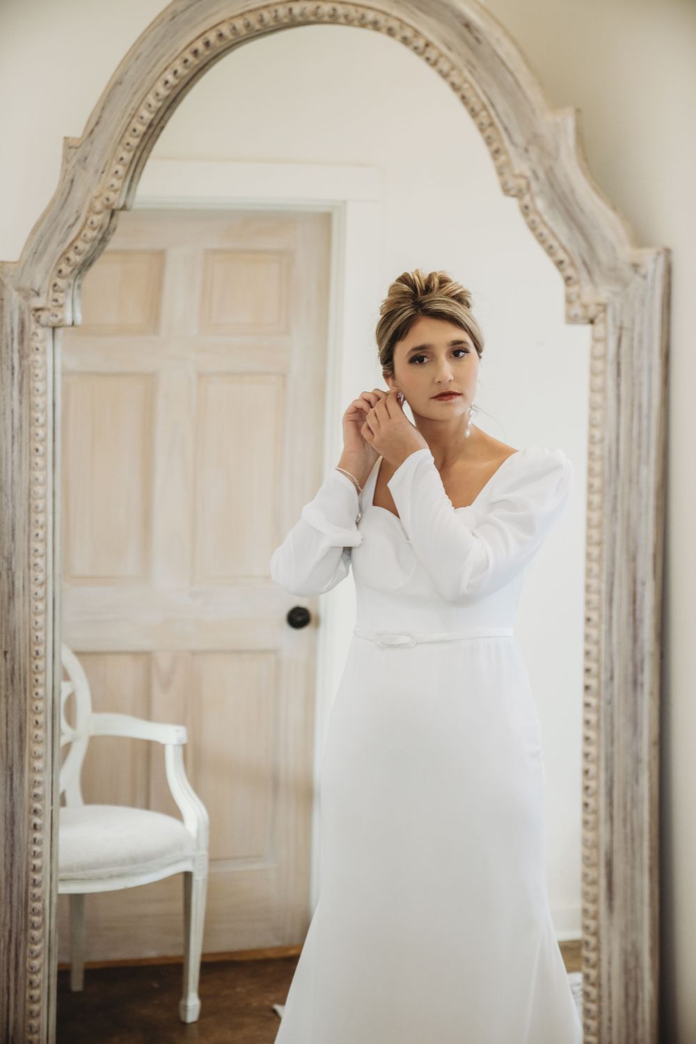 Series of photos showing a bride wrapped in a white towel looking in an ornate mirror.