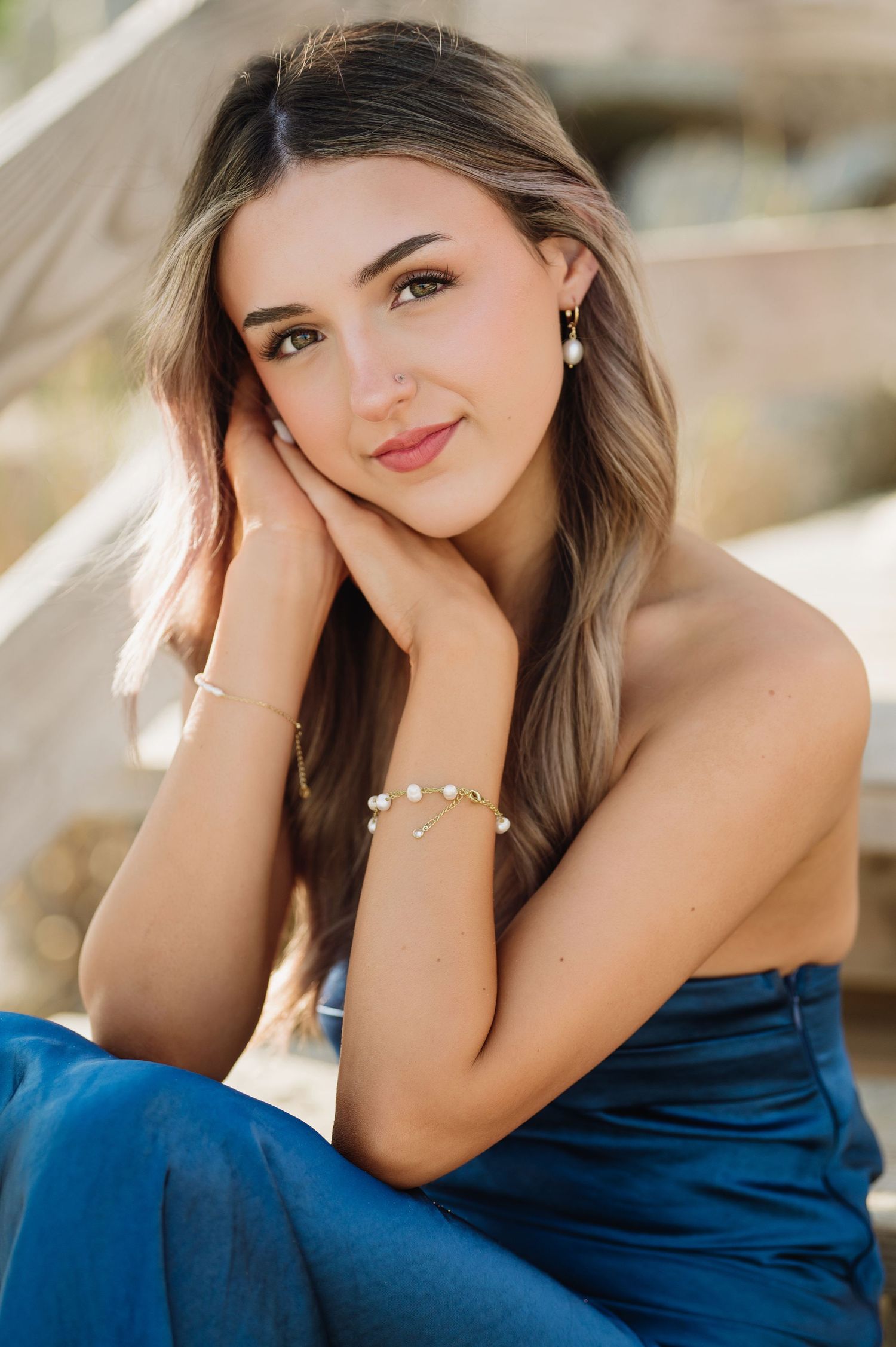A person in a blue velvet dress poses for close-up portraits.