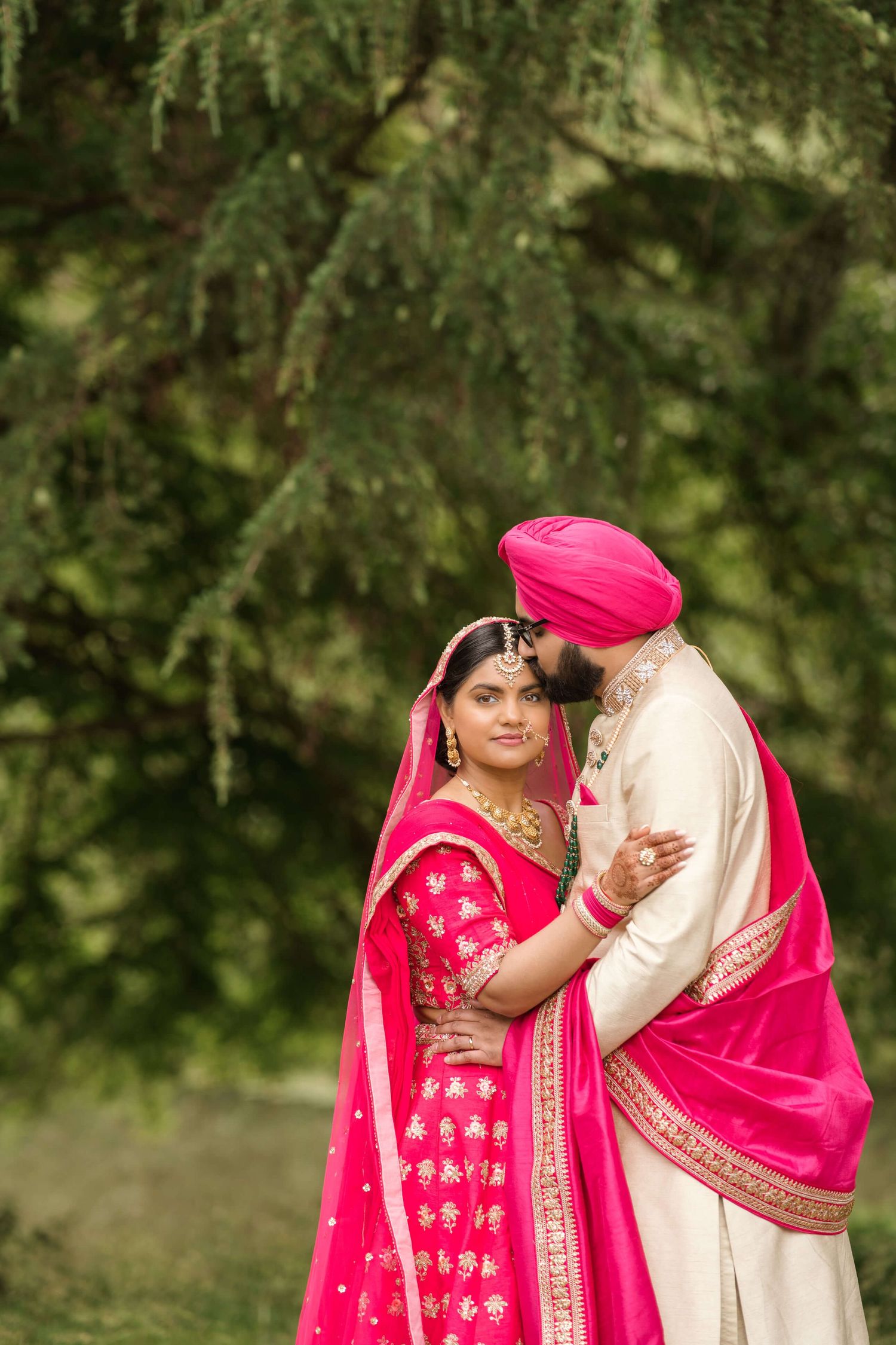 Sikh groom and bride expressing their love after matrimony captured by the cameraman