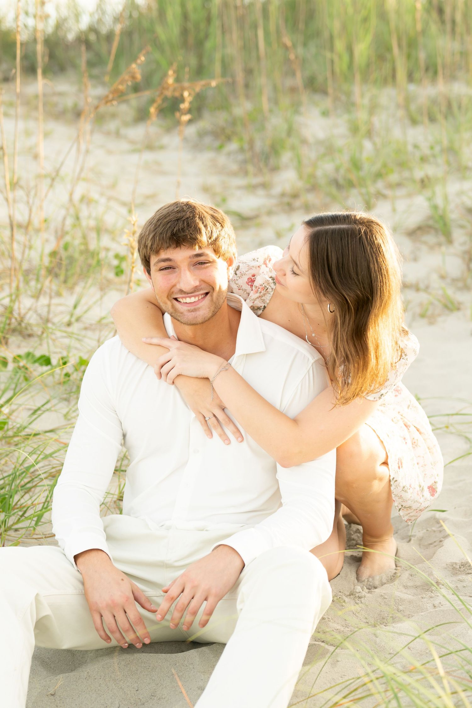 Couple shares a happy moment together on a scenic road surrounded by trees.