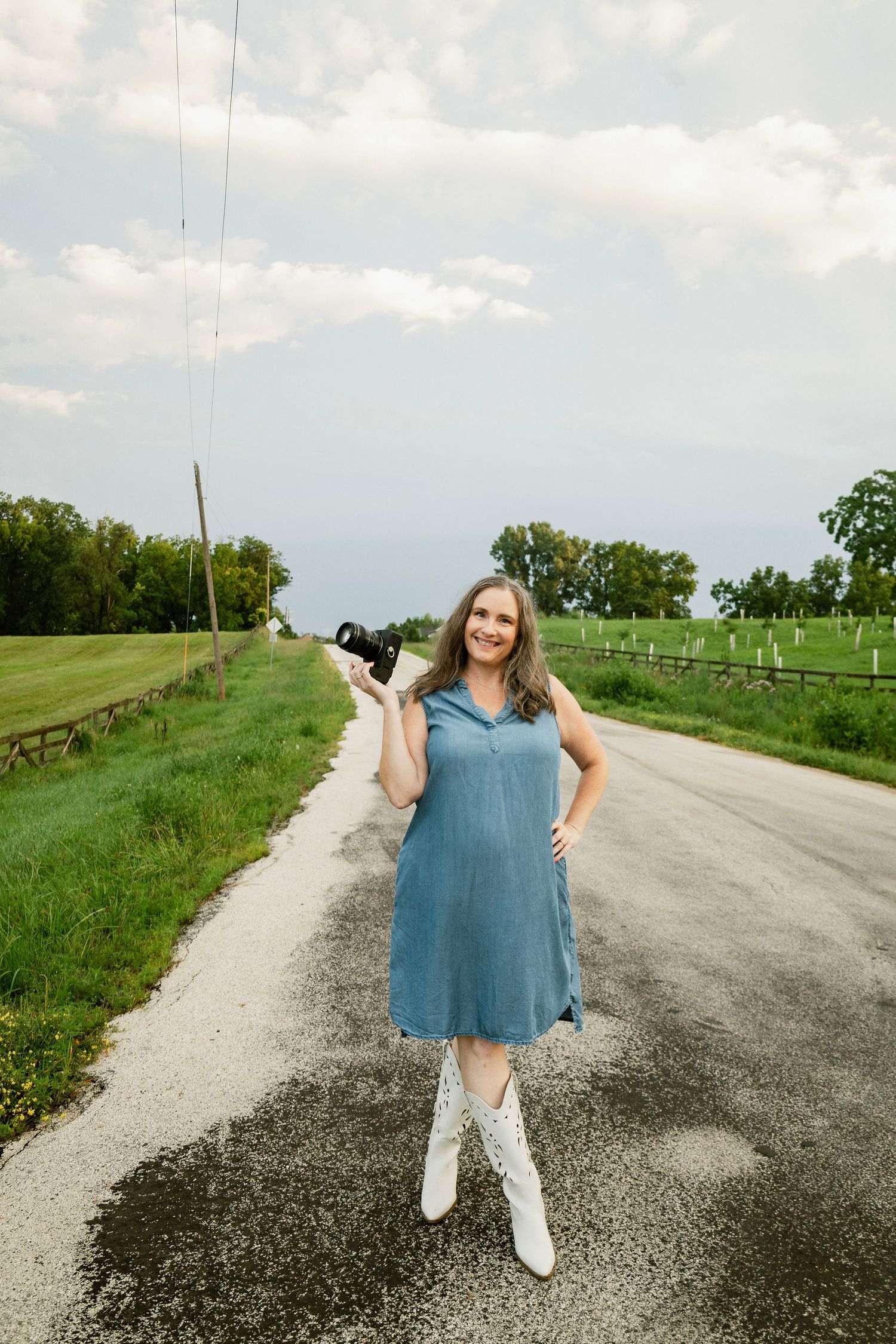 Marion and Cedar Rapids photographer, Nichole poses on a country road with her camera.