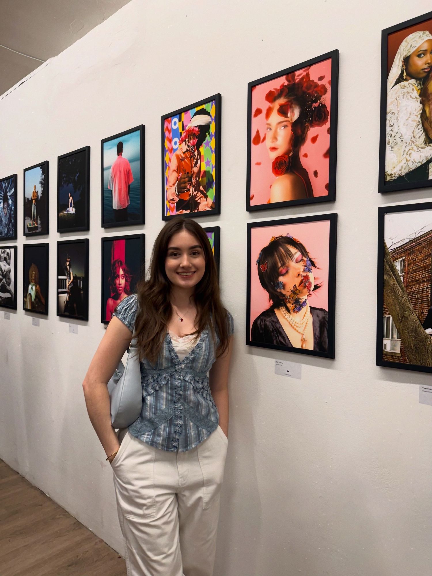 A girl standing in front of framed photographic works