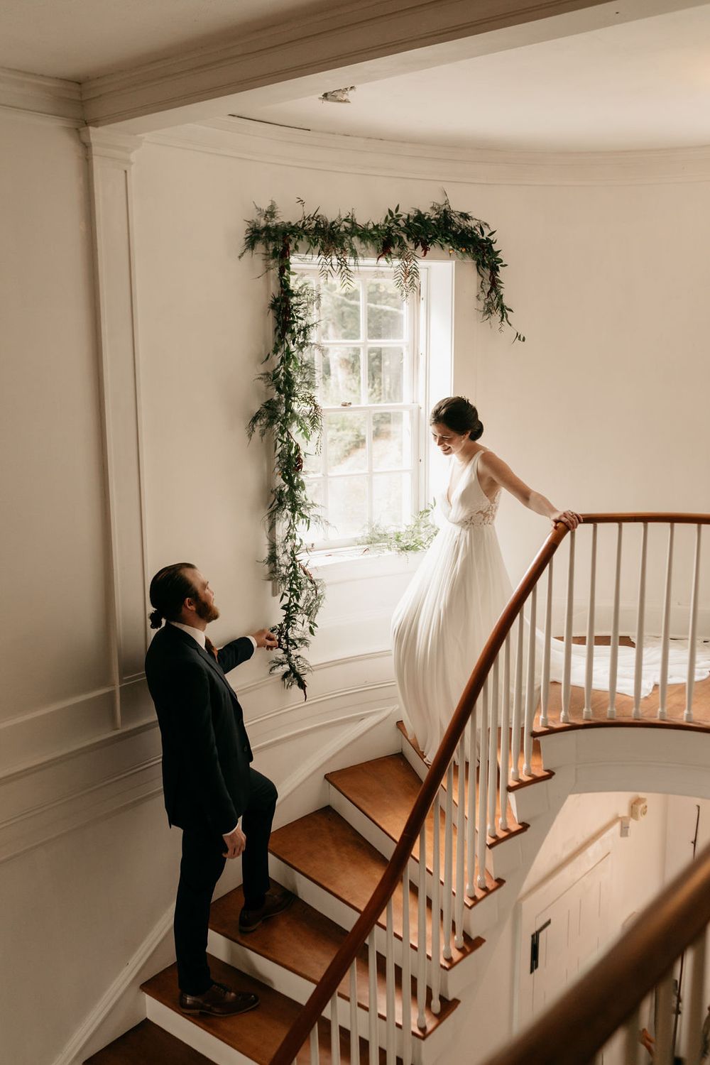 A sequence of photos showing someone walking up a white staircase with greenery garland decorating the window frame.