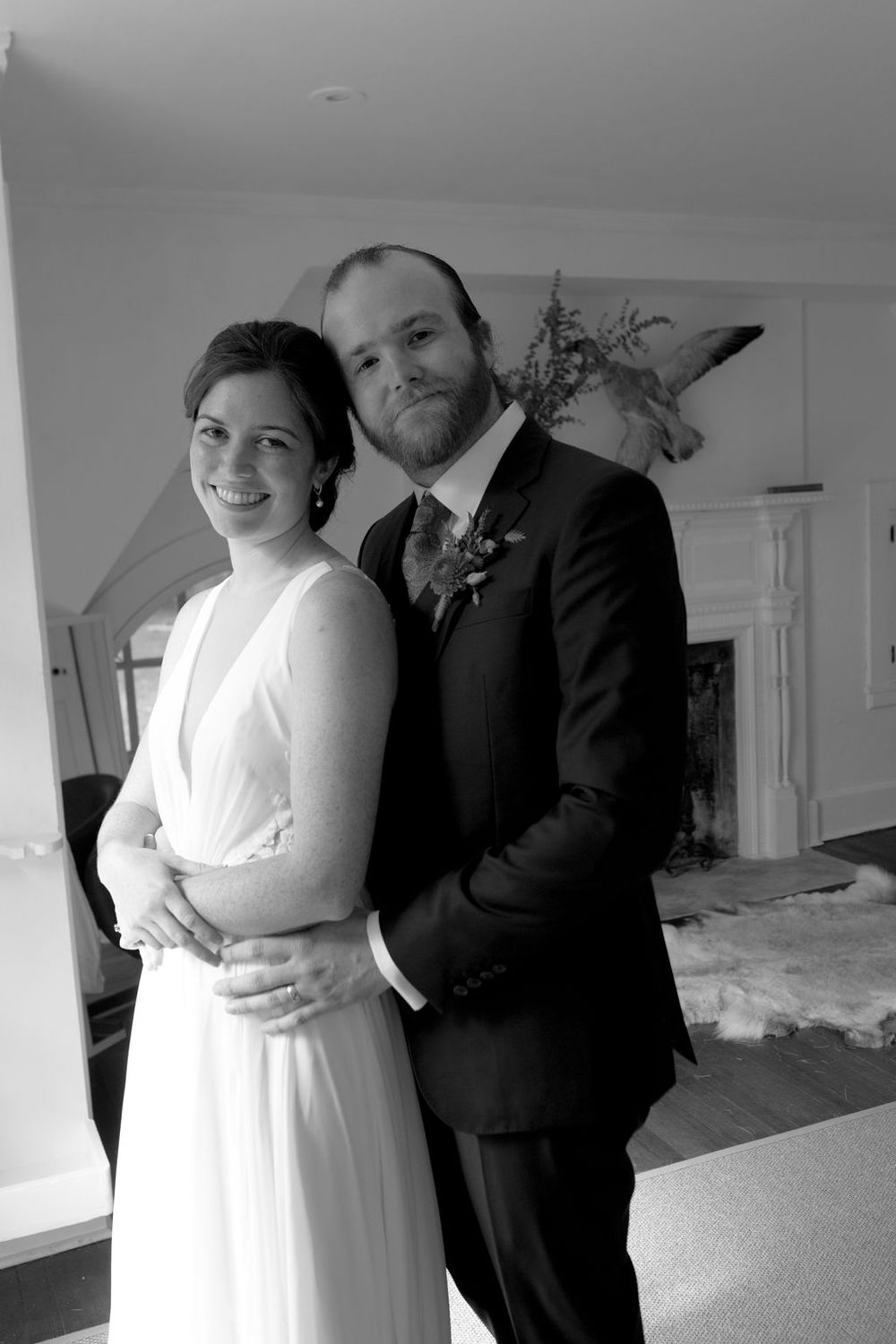 Black and white wedding photos showing a couple posing indoors in formal attire.