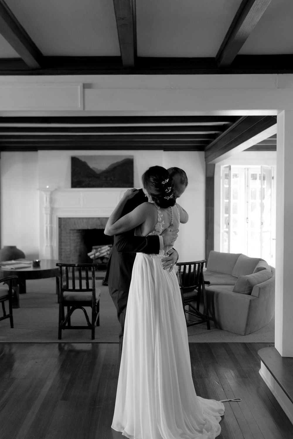 A series of black and white photographs showing the final moments of wedding preparation in an elegant room.