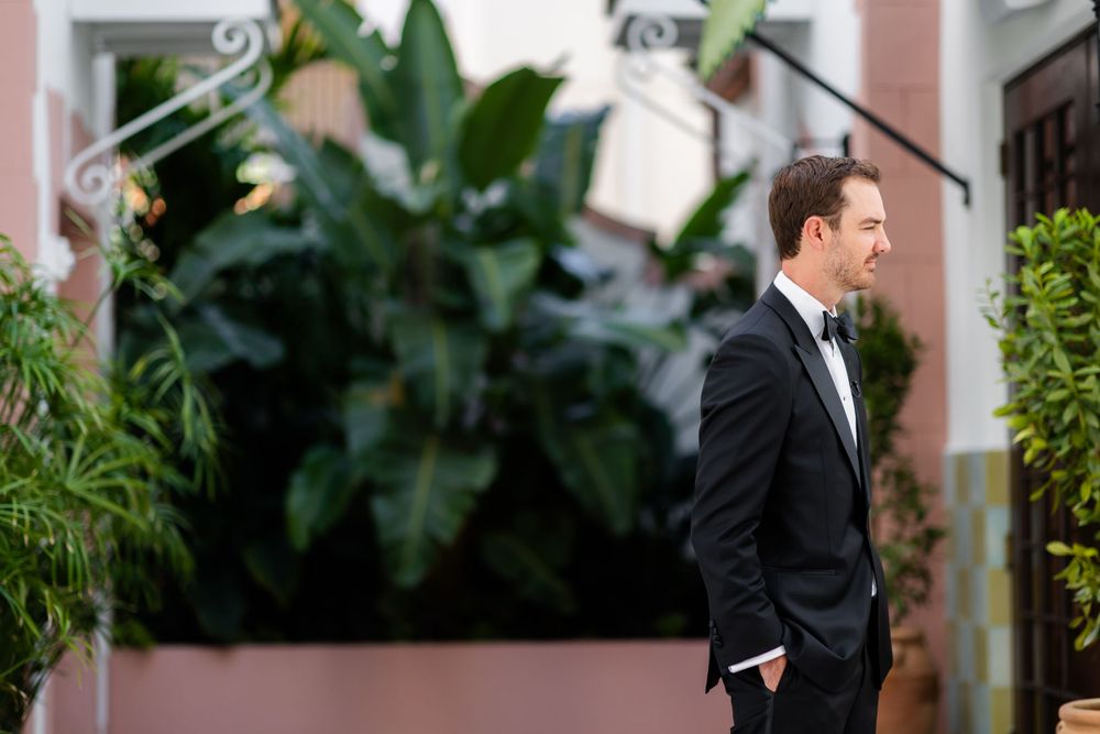 Wedding couple's first look moment captured in a lush garden setting.