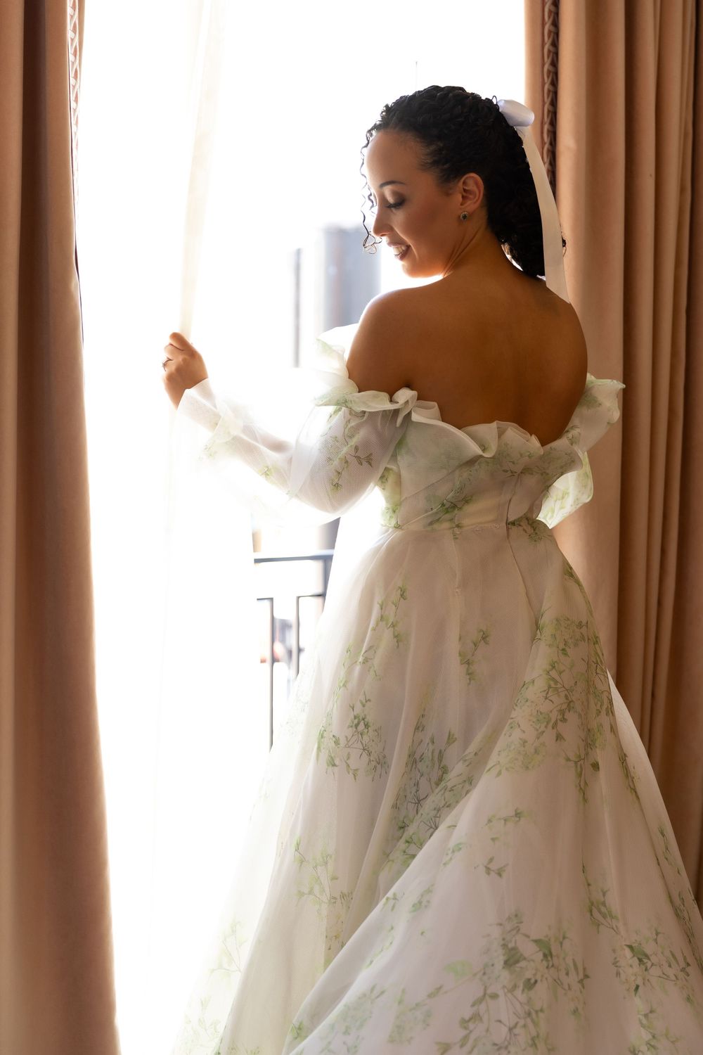 Elegant bridal gown with off-shoulder design and delicate floral embellishments.