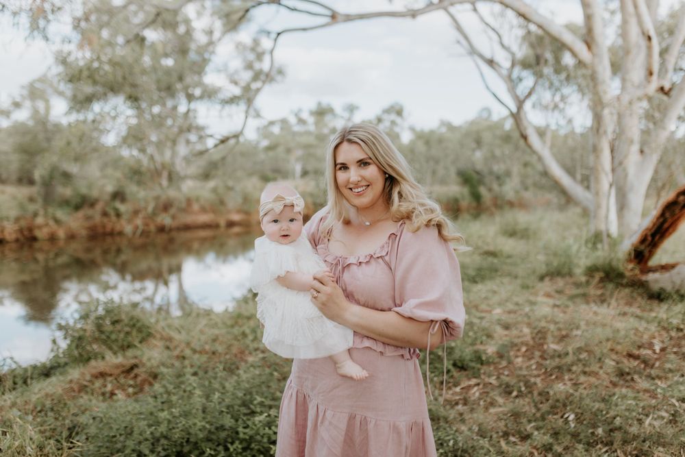 mother and daughter pose for photo in front of river in Mount Isa