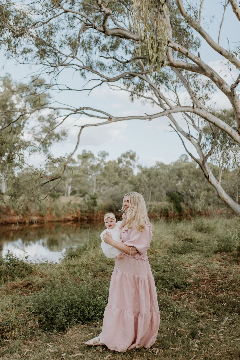 motherhood session in mount isa. mother and daughter walk along river