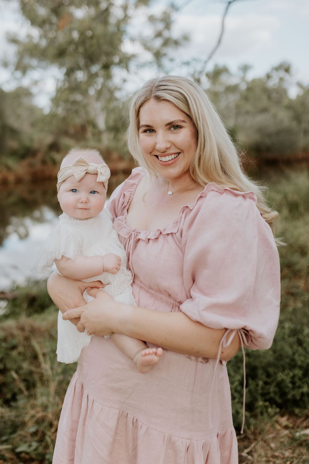 motherhood session in mount isa. mother and daughter pose in from of east leichardt reiver