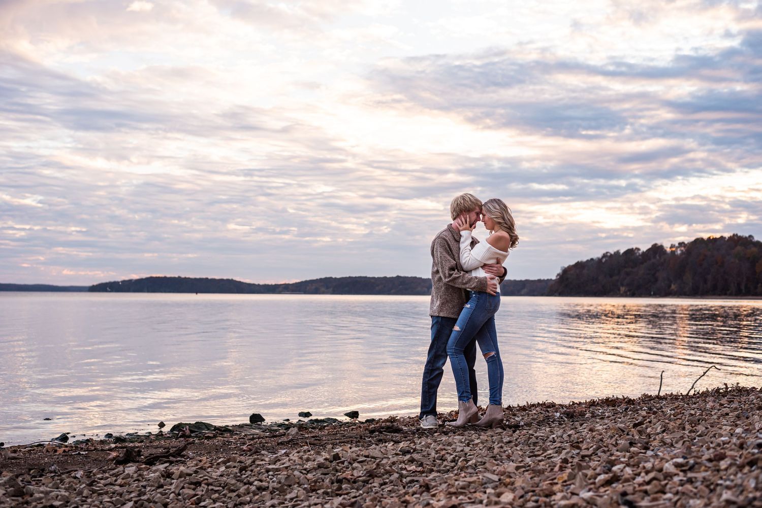A couple gazing into each other's eyes by the water on Kentucky lake in Kuttawa, Kentucky.