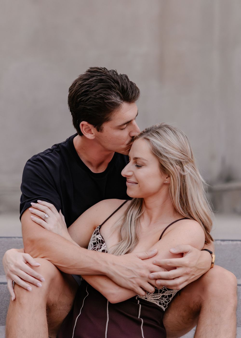 A romantic couple sits close together on steps sharing intimate moments in a series of candid photos.