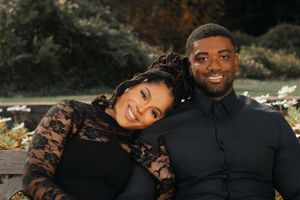 Romantic outdoor couple photoshoot featuring elegant black lace dress details.