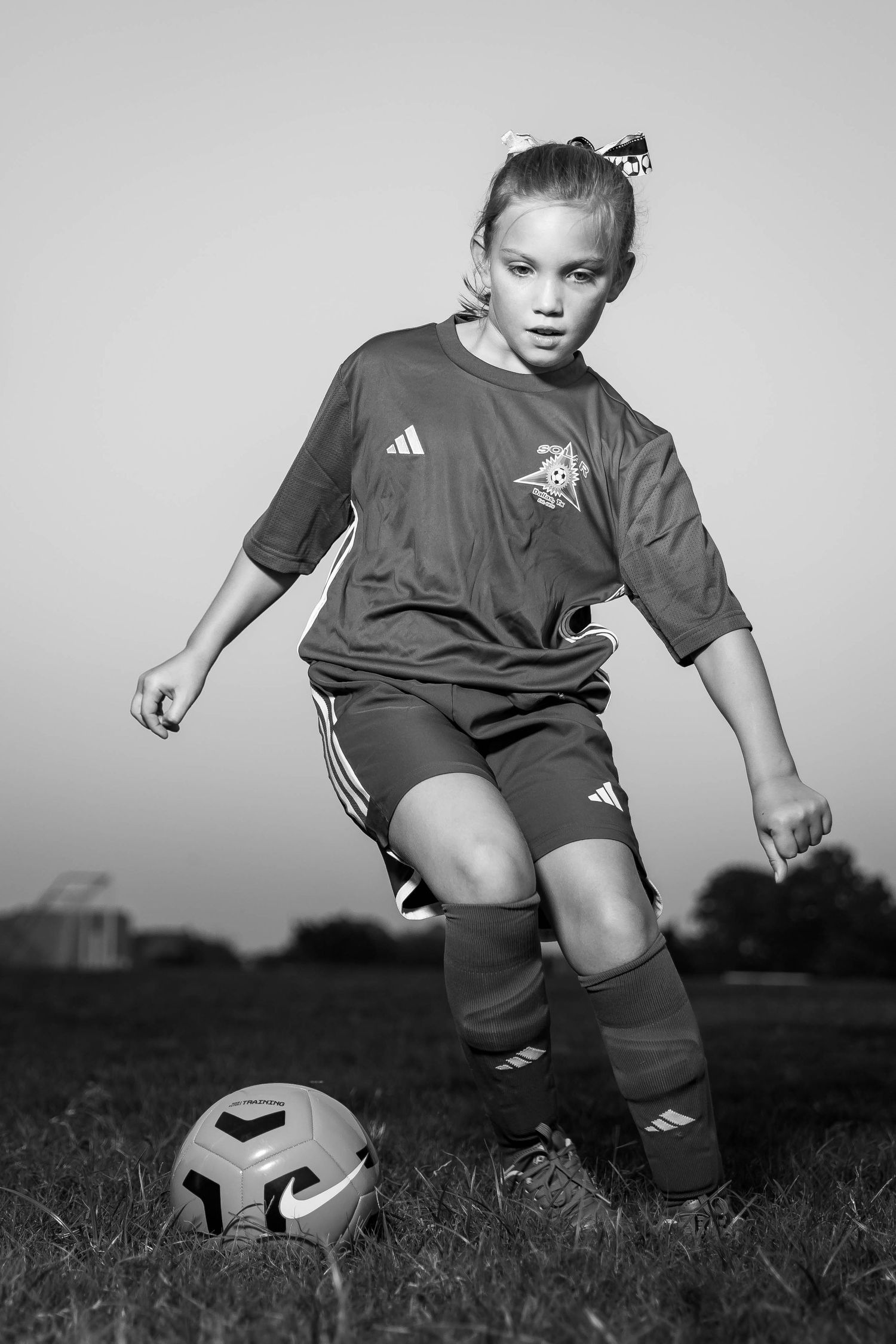 Young soccer player in Adidas uniform demonstrates dribbling technique through sequence of close-up action shots.