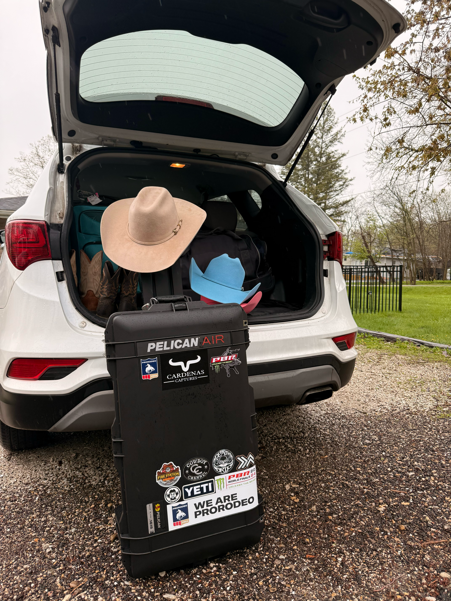 Pelican storage cases loaded in the trunk of multiple vehicles.