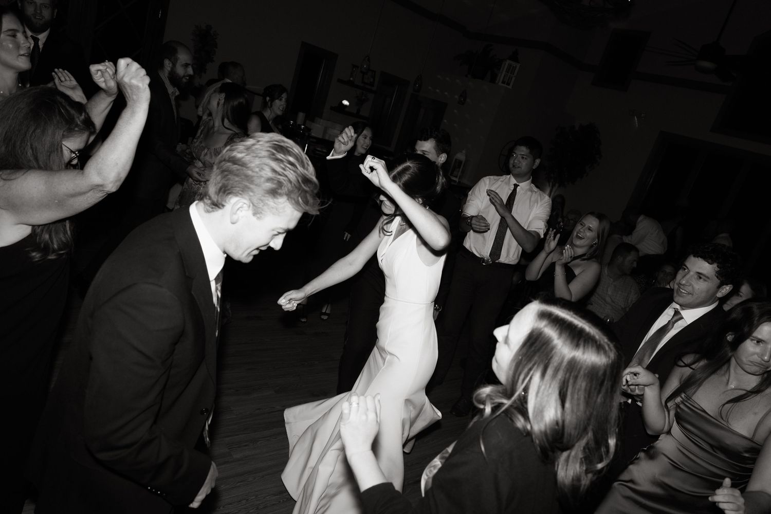 Sequence of black and white photos showing people dancing and celebrating at a lively party or nightclub.