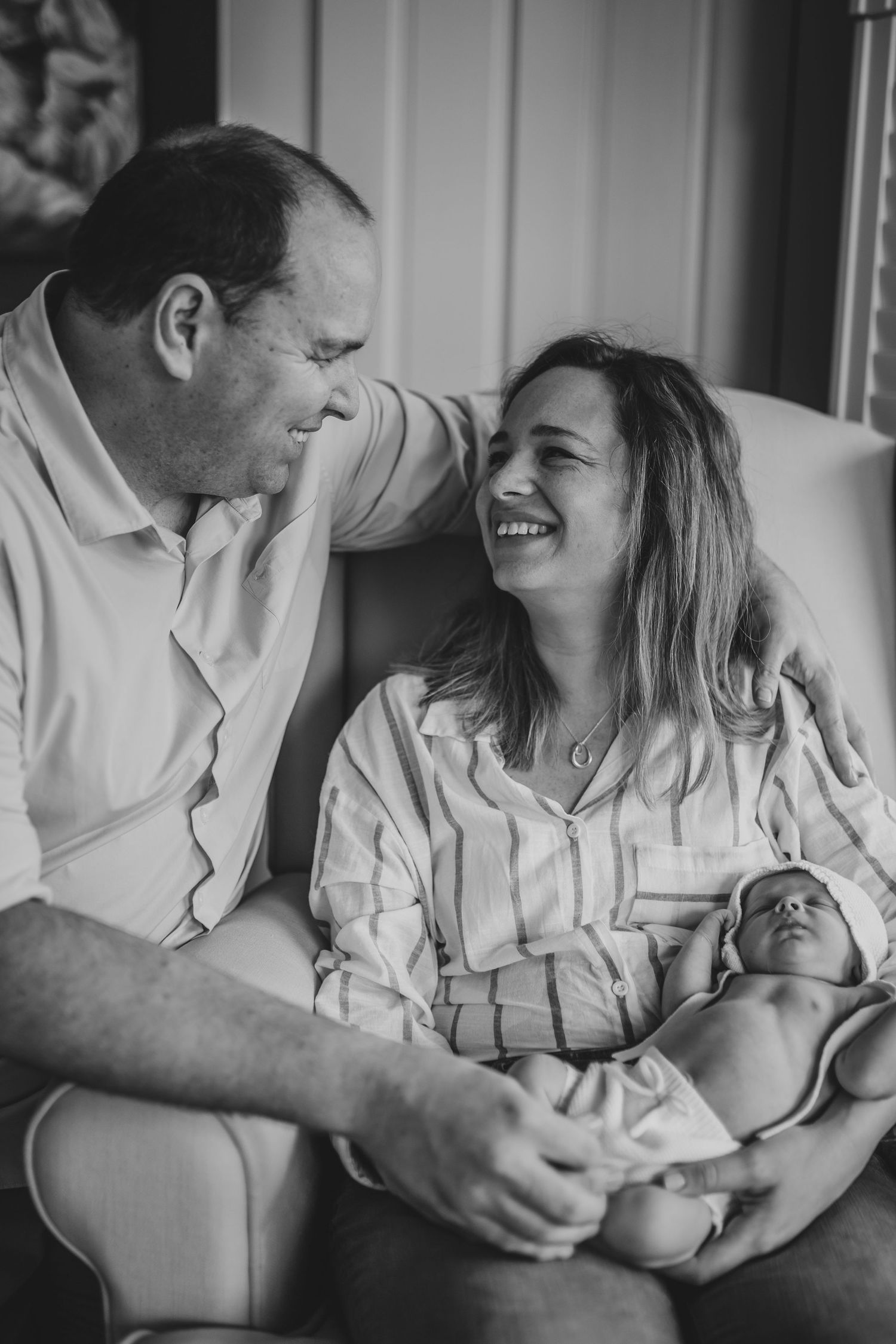 Close-up of parent holding newborn’s head during a natural in-home baby session in Bromley