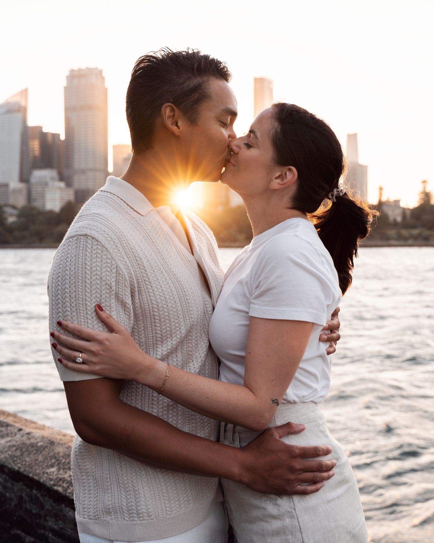 engagement photographer in sydney near me captures a lovely kiss with golden hour of a newly engaged couple in Sydney