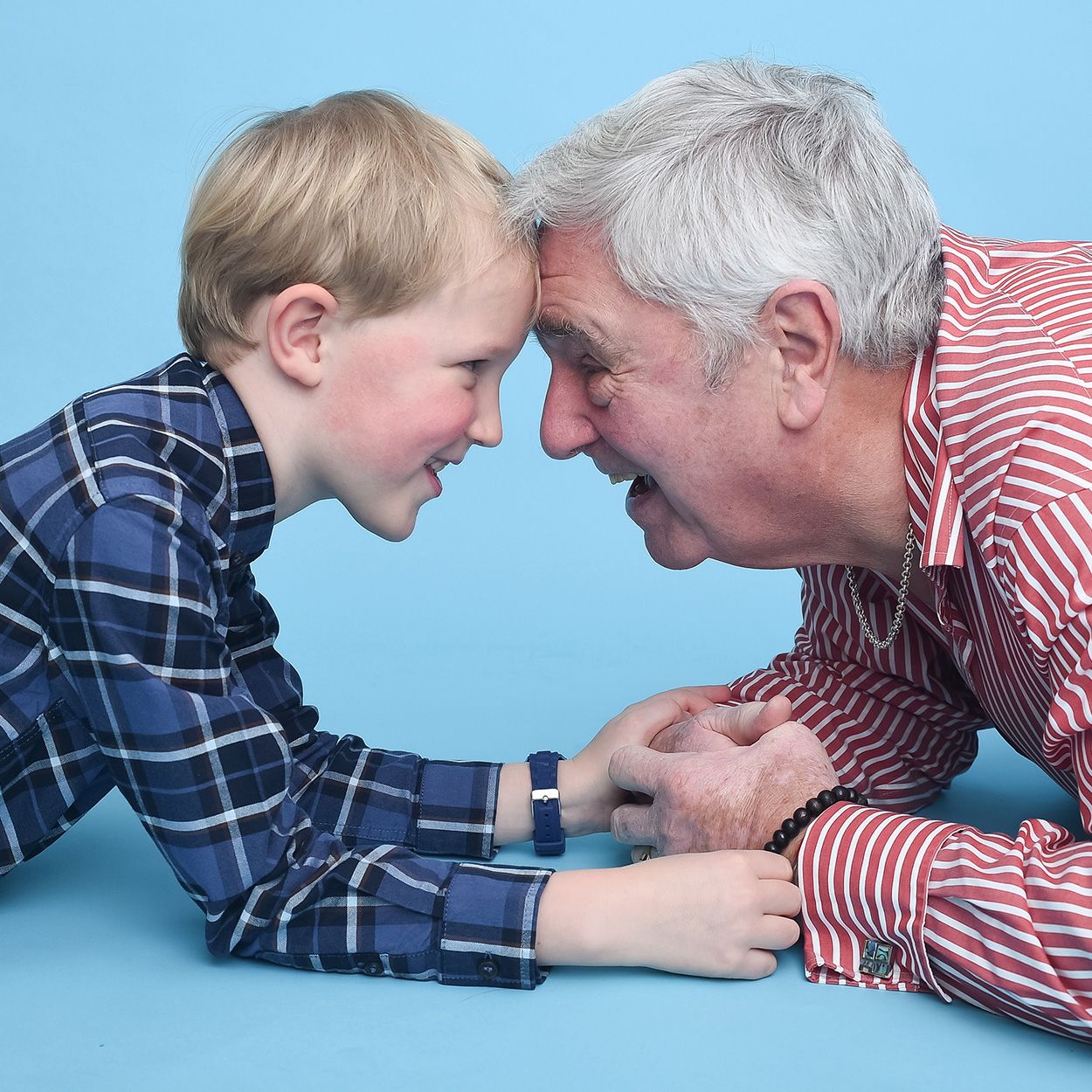 A candid Grandfather - Grandson moment captured during a light-filled photography session at Abigail's Studio.