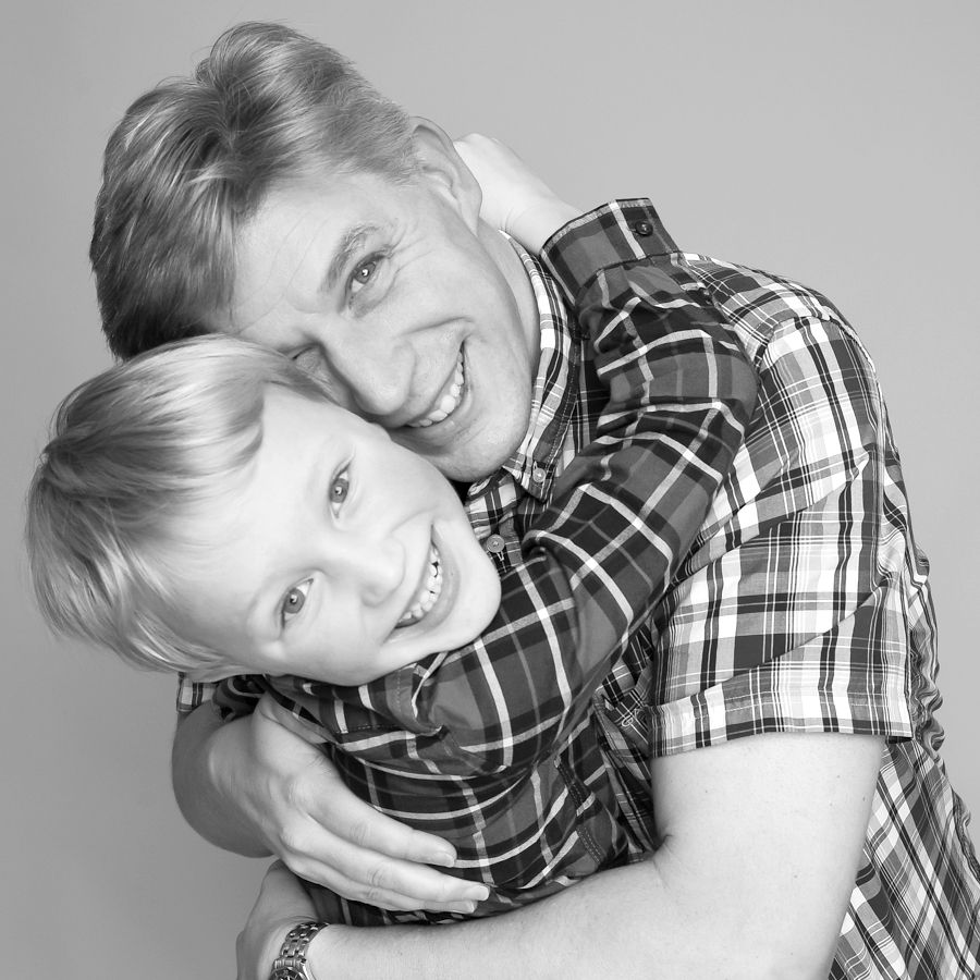 Captured moment of Dad and child sharing a hug during a photography session at Abigail’s Studio