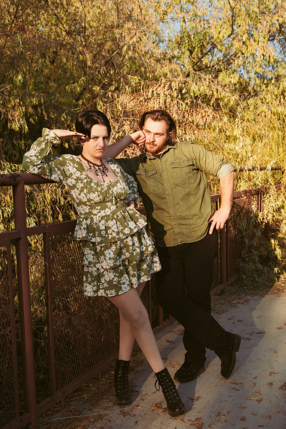 A sequence of dance poses photographed outdoors against autumn foliage and a wooden fence at sunset.