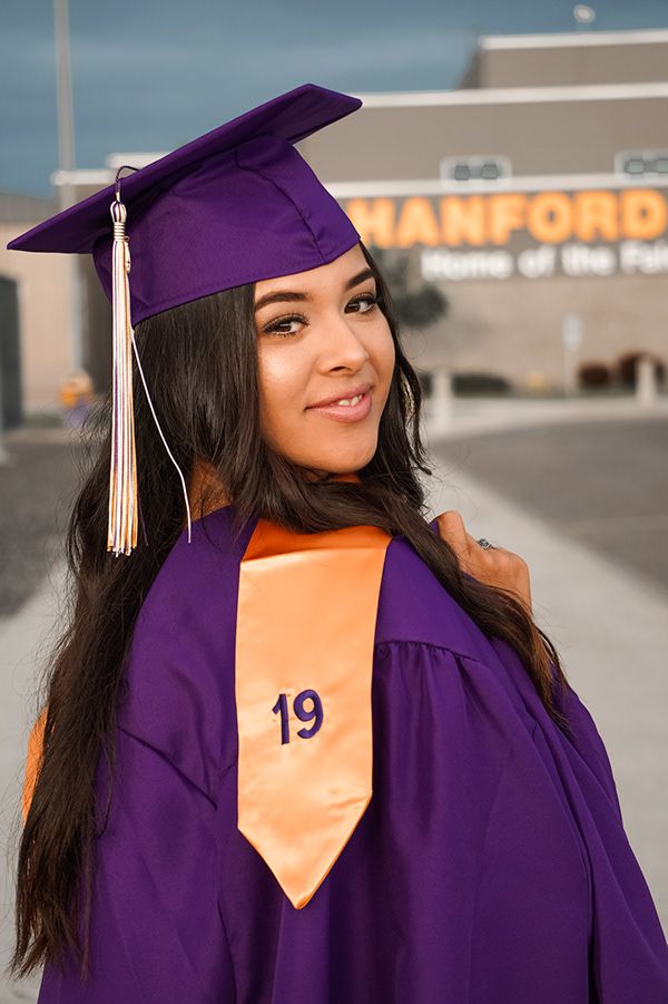 High school senior wearing cap and gown during graduation session in Tri-Cities WA
