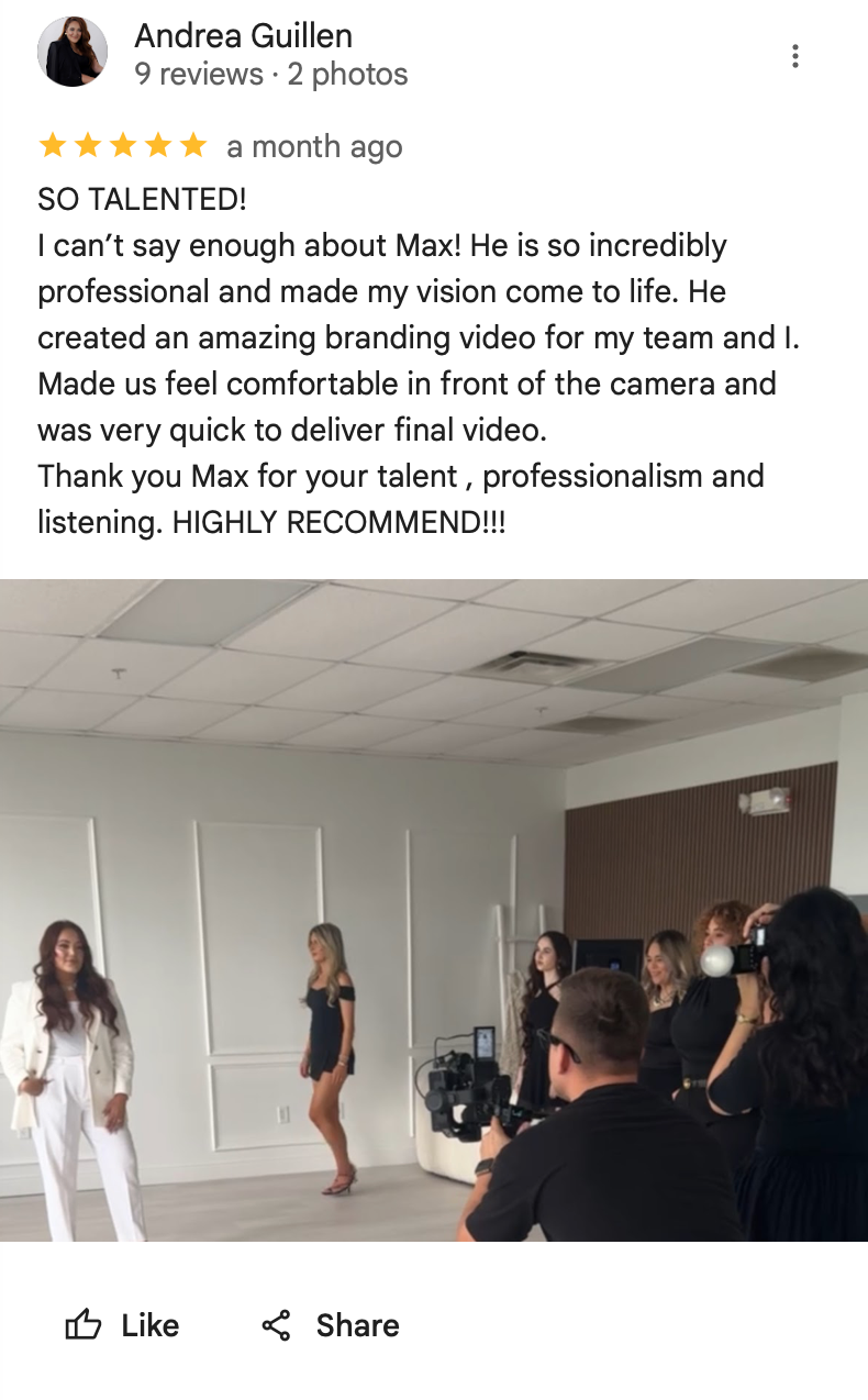 Behind-the-scenes photo of a professional video shoot with camera operator filming in a white studio setting.