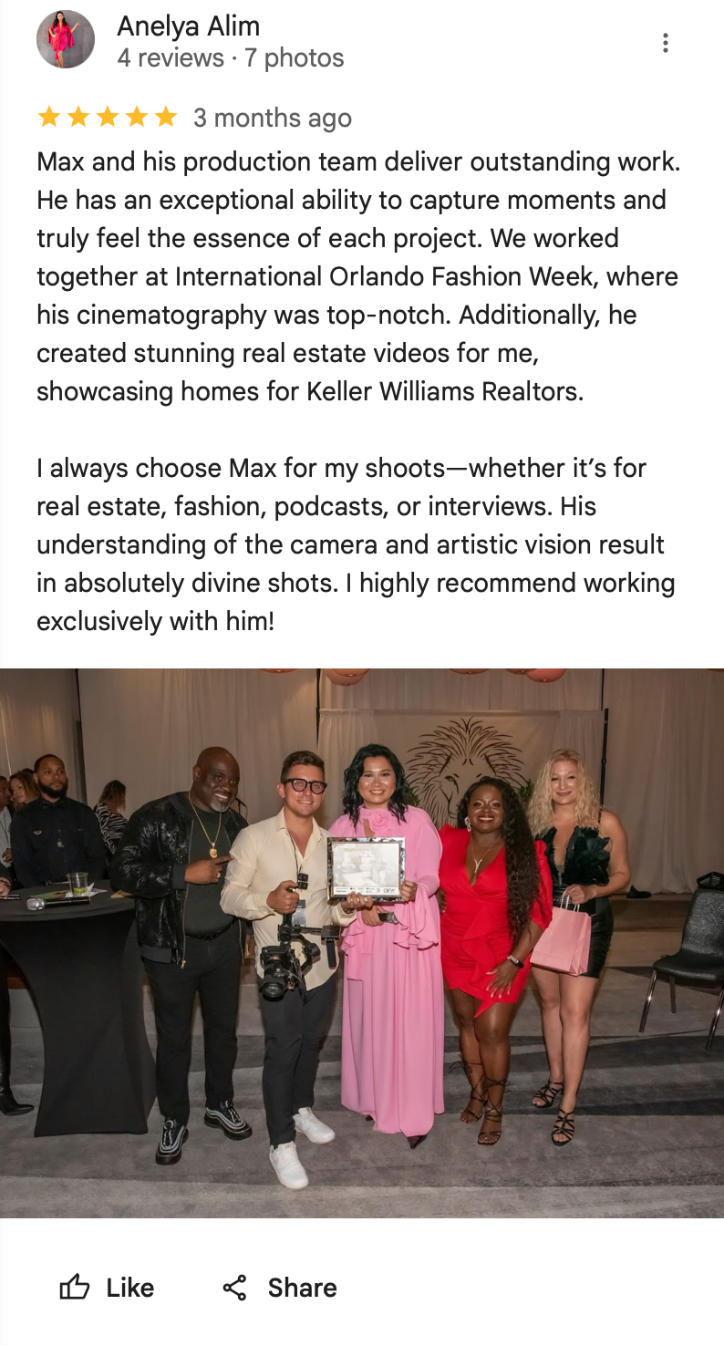 Group photo showing people celebrating at an event with someone holding an award or certificate.