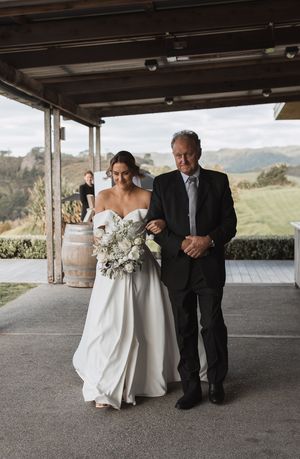 Wedding ceremony scene at an outdoor venue with scenic mountain views in the background.