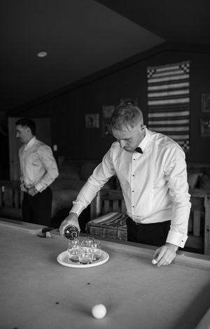 Black and white sequence showing a pool game being played on a table with American flags visible in background.